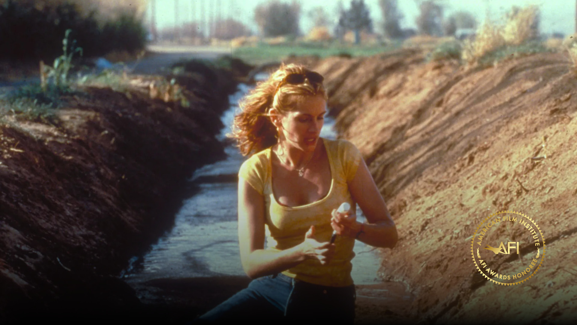 ERIN BROCKOVICH - Julia Roberts as Erin Brockovich taking water sample