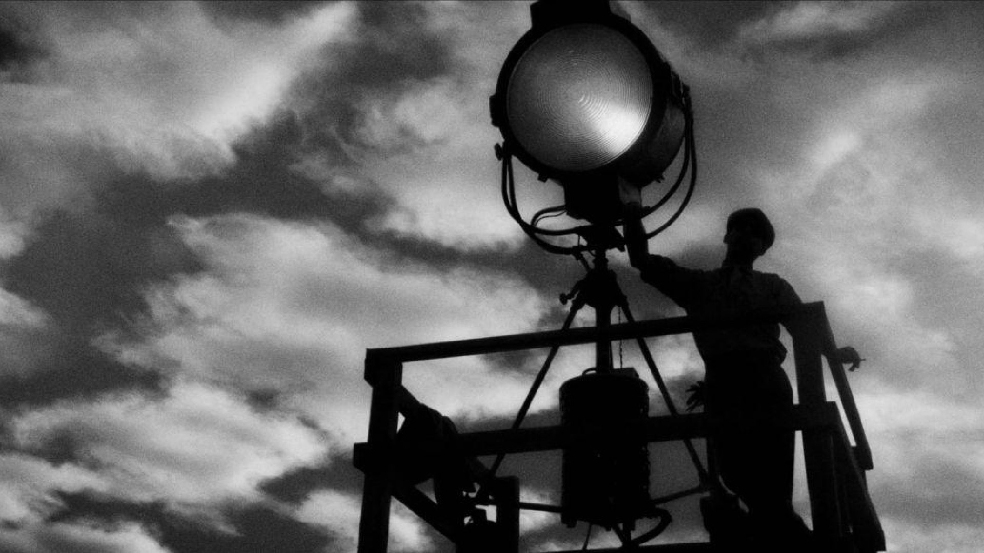 MANK film still of a man holding a spotlight