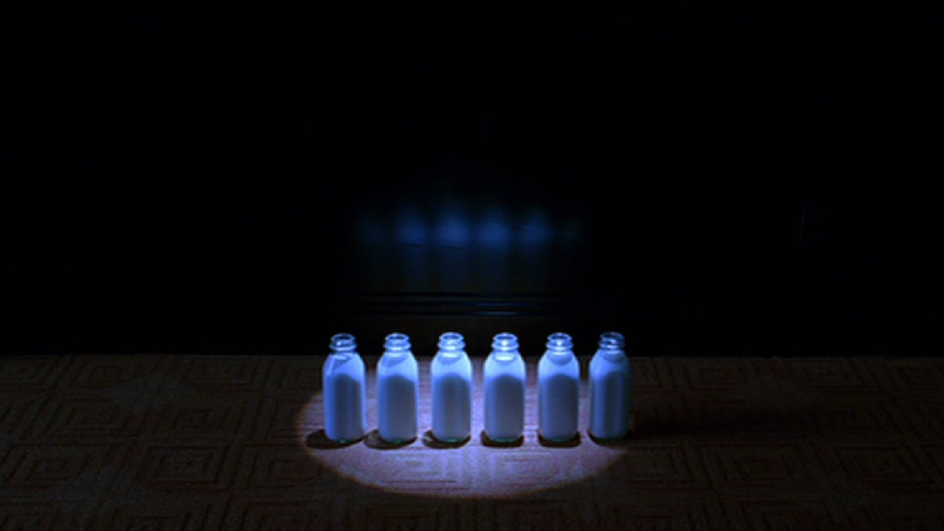 THE AVIATOR film still of six bottles of milk on a table