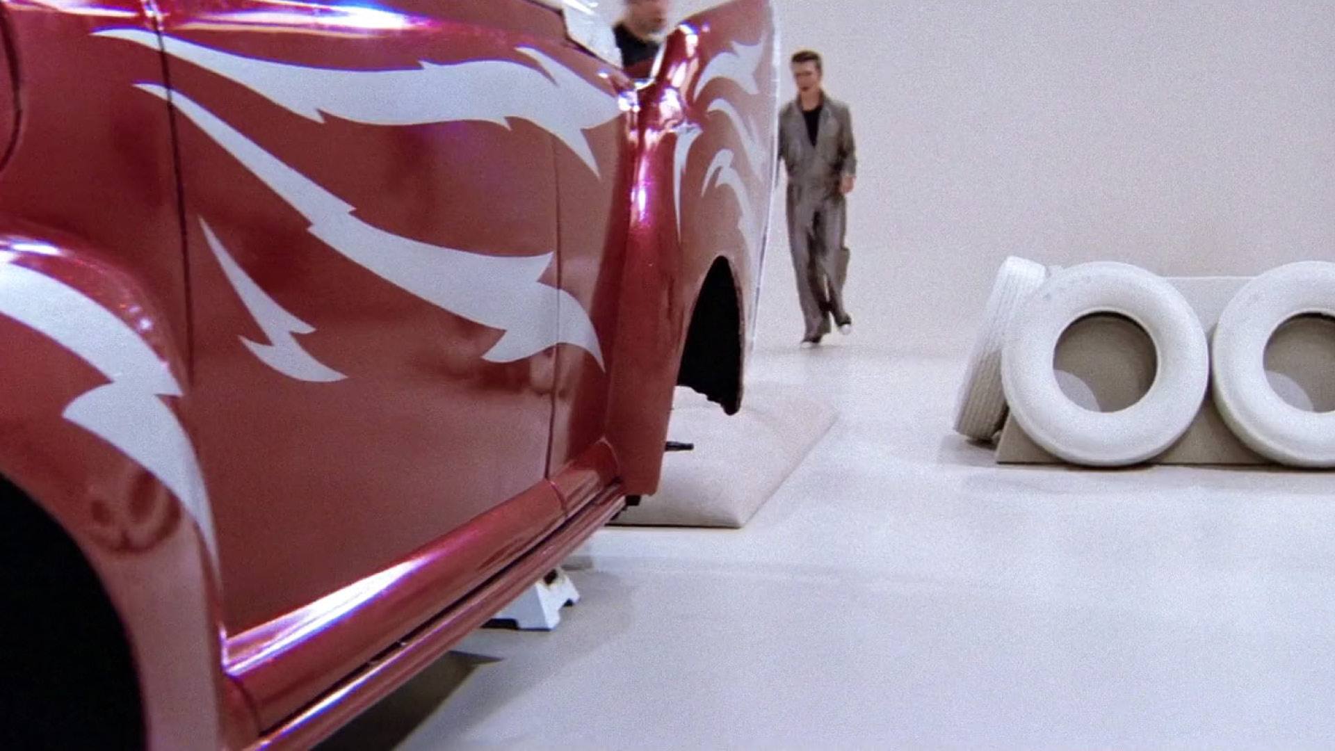 GREASE film still of the side of a red hot rod