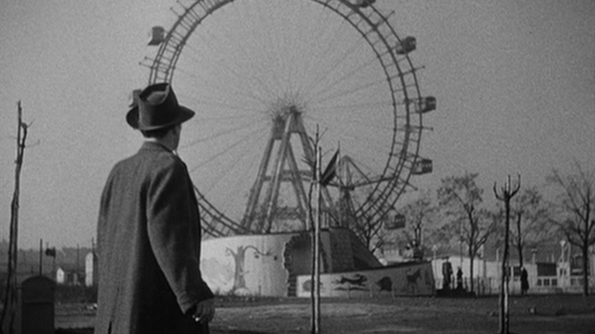 THE THIRD MAN film still of a man standing in front of a ferris wheel