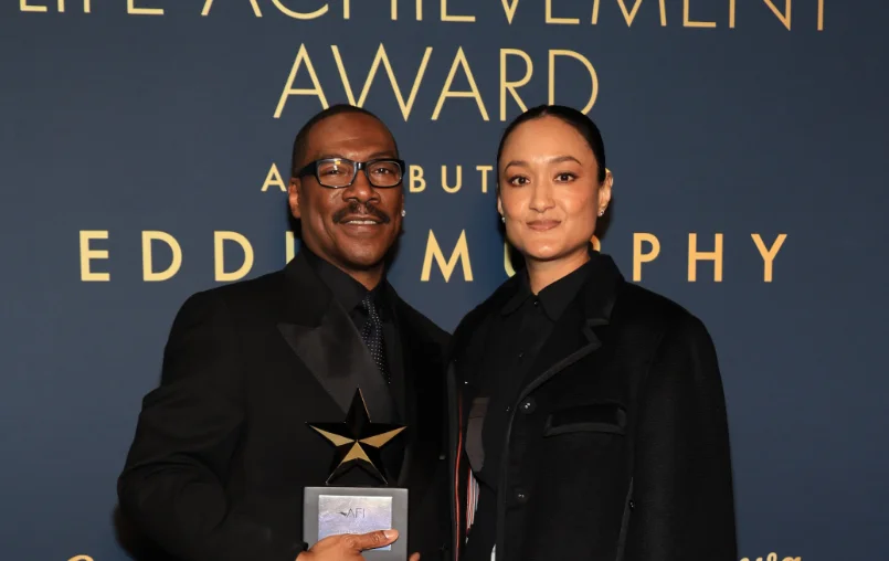 ADA-LAA26 (L-R) Eddie Murphy, recipient of the AFI Life Achievement Award, and Autumn Durald Arkapaw, recipient of the Franklin J. Schaffner Alumni Medal, pose backstage at the 51st AFI Life Achievement Award: A Tribute to Eddie Murphy at the Dolby Theatre. (Photo by Savion Washington/Getty Images for AFI)