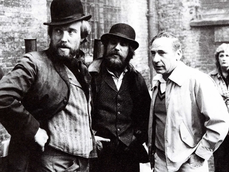 Spotlight-0626-2-Pressbook Mel Brooks (right) on set with screenwriters Eric Bergren and Christopher De Vore. Source: "The Elephant Man: The Book of the Film," Book Club Associates, 1981.